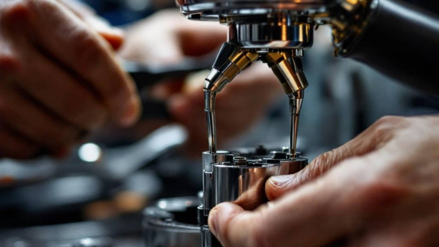 Close-up of hands working on a coffee machine.